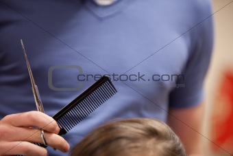 Close up of scissors and a comb