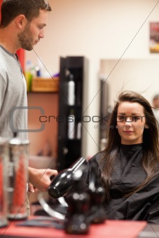 Portrait of a male hairdresser blowing hair