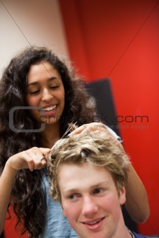 Portrait of a female hairdresser cutting hair