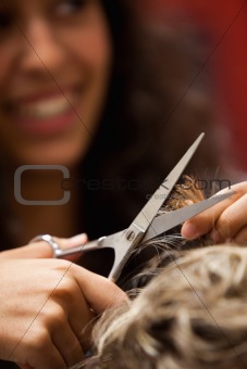 Portrait of a hairdresser cutting hair