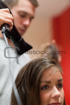 Portrait of a handsome hairdresser blowing hair
