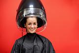 Woman under a hairdressing machine