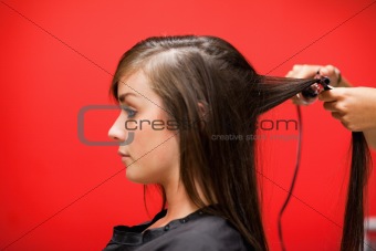 Woman having her hair straightened