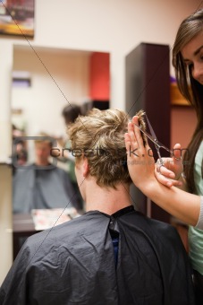 Portrait of a blond-haired man having a haircut