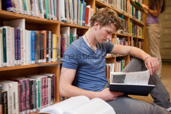 Male student reading a book