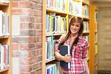 Cute young female student holding a book