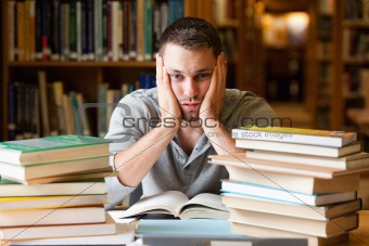 Depressed student having a lot to read