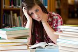 Depressed student surrounded by books