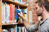 Male student picking a book