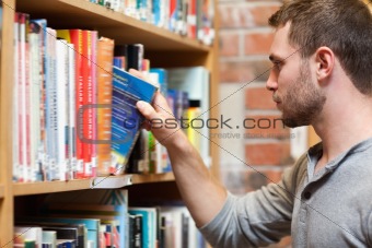 Male student picking a book
