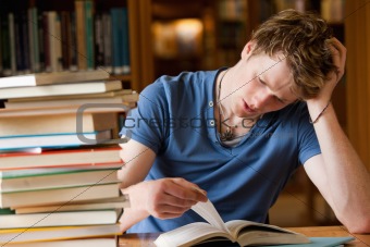 Tired man reading a book