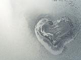 Frozen heart in the frosty window