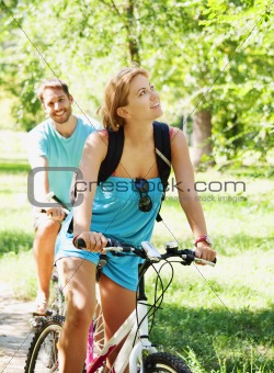 Young happy couple riding a bicycle