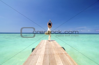 asian yogo on beautiful beach