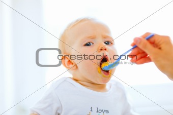 Eat smeared pretty baby open mouth for spoon
