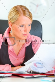 Modern business woman working with documents and checking records
