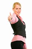 Smiling business woman showing thumbs up gesture
