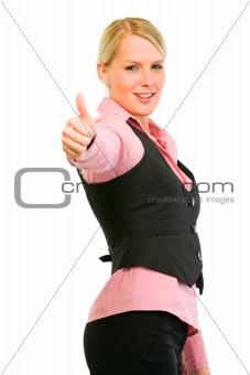 Smiling business woman showing thumbs up gesture
