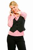 Smiling business woman talking on cell phone and pointing on you
