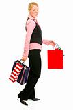 Full length portrait of smiling business woman with shopping bags
