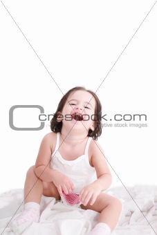 laughing little girl on her bed