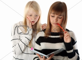 Two beautiful girls read diary book