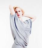 portrait of sexy blond girl in over-sized gray shirt - isolated on light gray