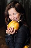 Smiling girl with pumpkin