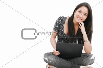 attractive young female sitting on the floor using laptop 