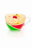 Jelly with banana and cherry isolated on white background