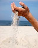 Sand falling from the man's hand 