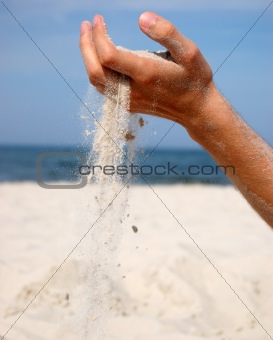 Sand falling from the man's hand 