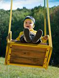 Cute little boy on a swing