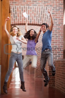 Portrait of successful students jumping