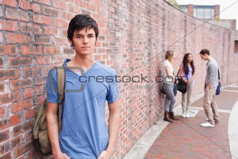 Student posing while his friends are talking