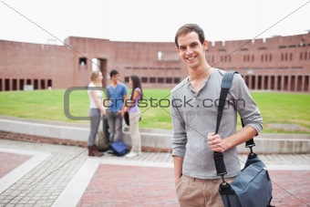 Student posing while his classmates are talking