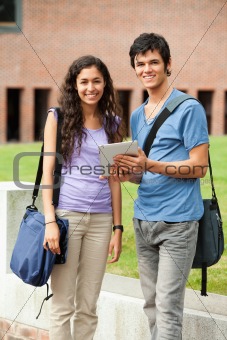 Portrait of a couple holding a tablet computer
