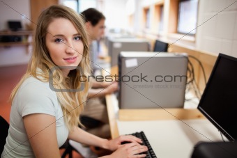 Student posing with a computer