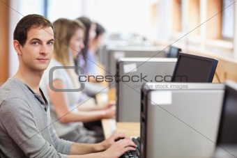 Male student posing with a computer