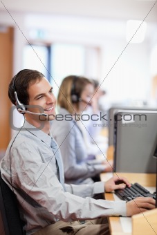 Portrait of a smiling customer assistant using a headset