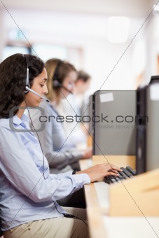 Portrait of a customer assistant working with a computer