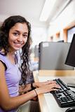 Portrait of a cute smiling student with a computer