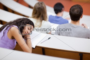 Young student sleeping during a lecture