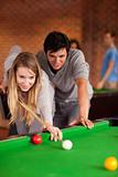 Portrait of a couple playing snooker