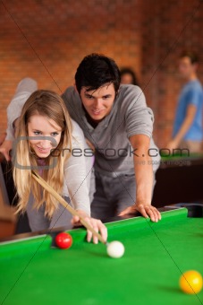 Portrait of a couple playing snooker