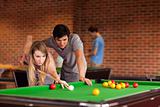 Couple playing snooker
