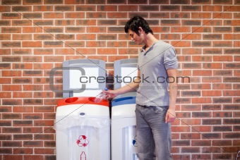 Young man recycling