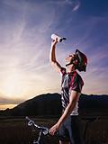 portrait of man training on mountain bike at sunset