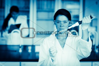 Scientist dropping liquid in a test tube