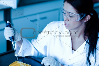 Science student dropping liquid in test tube